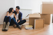 © ADDICTIVE STOCK - Cheerful pair sitting in boxes