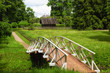 White wooden bridge in the old park in the village of Mikhailovskoye, Pskov region, Russia