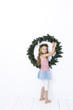 © epiximages - Happy beautiful girl holding a christmas wreath