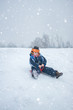 © Bojan - Little boy enjoying sleigh ride during snowfall.