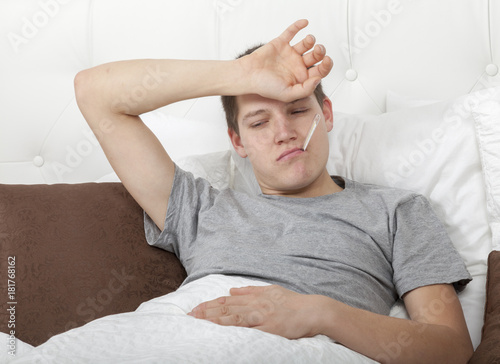 Kranker Mann Im Bett Mit Fieberthermometer Im Mund Buy This Stock Photo And Explore Similar Images At Adobe Stock Adobe Stock