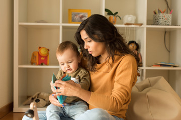 Wall Mural - mother playing with toddler at home