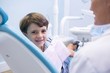 © WavebreakMediaMicro - Portrait of cute boy sitting on dentist chair by dentist