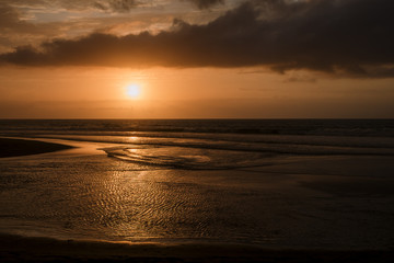 Wall Mural - dramatic sunset clouds reflected on the water sea. tropical beach landscape at golden hour