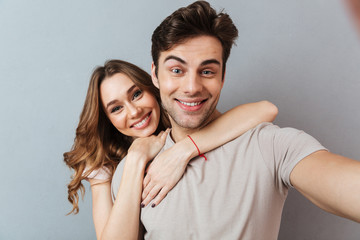 Poster - Portrait of a cheerful young couple hugging