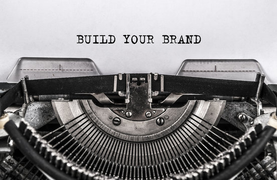 BUILD YOUR BRAND typed words on old vintage typewriter. close up