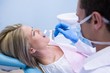 © WavebreakMediaMicro - Dentist examining woman at clinic