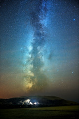 wales milky way over a distant house