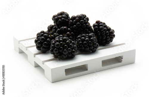 Fényképezés Blackberries on pallet isolated on white background.