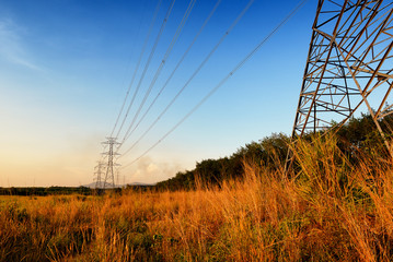 Wall Mural - high voltage post or high voltage tower at sunset