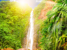 Carbet Falls Or Les Chutes Du Carbet At Sunset, One Of Three Waterfalls In Tropical Rainforest On Carbet River, Guadeloupe Island, French Caribbean. The Falls Are One Of The Most Popular Visitor Sites