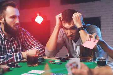 Young people play poker at the table.