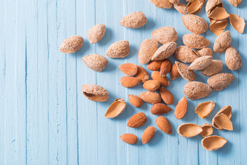 Wall Mural - salted almonds in shell on wooden background