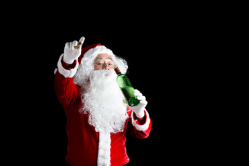 Happy Santa drinking alcohol in green bottle over on black background