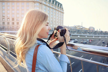 Wall Mural - Young female tourist taking photo outdoors