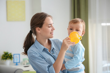 Poster - Woman feeding her baby at home