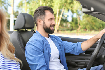 Happy young man driving a car