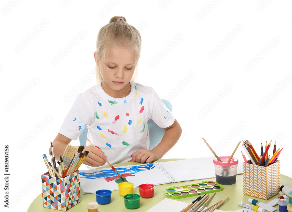 Cute little girl painting at table on white background