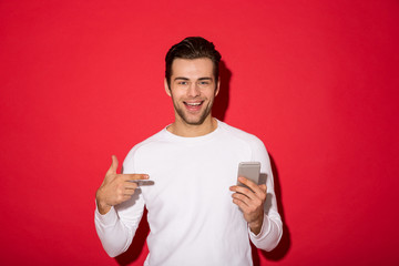 Wall Mural - Picture of smiling man in sweater looking at the camera