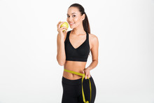 Portrait Of A Healthy Asian Fitness Woman Holding Apple