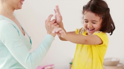 Wall Mural - mother and daughter having fun at home kitchen