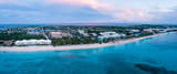 Fototapeta  - aerial panoramic view of seven mile beach in the tropical paradise of the cayman islands in the caribbean sea after sunset