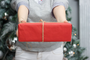 Canvas Print - Woman hands holding the red christmas box