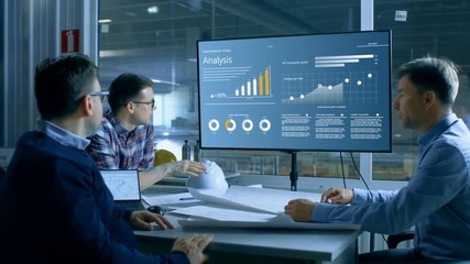 Poster - Chief Industrial Engineer Has Meeting with Management and Executives in the Heavy Industry Factory Have Quarterly Meeting Room, They Look at Production Statistics on a Big Screen.