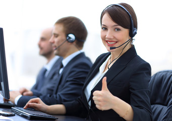 Poster - Manager of the call centre shows thumb up sitting at your Desk