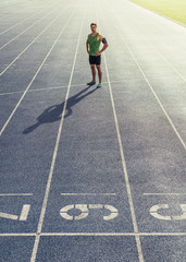 Wall Mural - sprinter standing on running track
