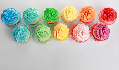 Poster - Tasty colorful cupcakes on white background