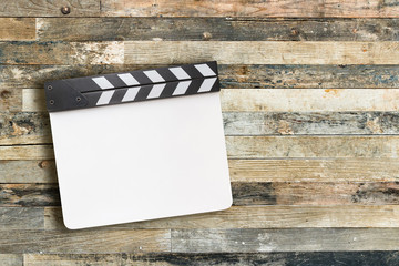Movie clapper board on wooden background with copy space