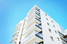 Modern Apartment Buildings On A Sunny Day With A Blue Sky. Facade Of A Modern Apartment Building
