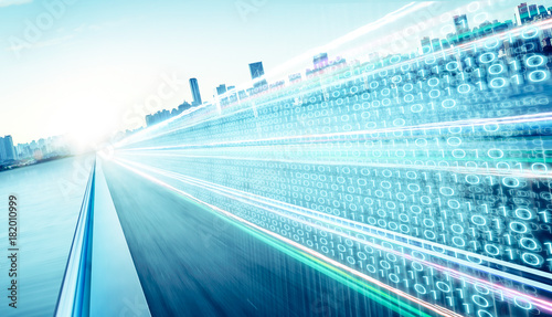 Fotografía Highway flyover with binary code numbers on motion blurred asphalt road , speed and faster digital matrix technology information concept