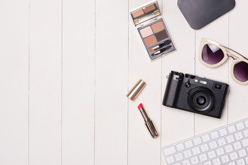 Sticker - Women cosmetics and fashion items on table with camera and passport. Top view