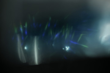 Wall Mural - real lens flare light effect. sparkle ray leak on black background. optical effect of spotlight. fla