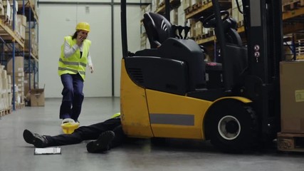 Poster - An injured worker after an accident in a warehouse.