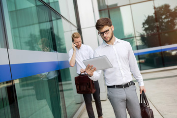 Wall Mural - Business colleagues in shirt walking outdoors