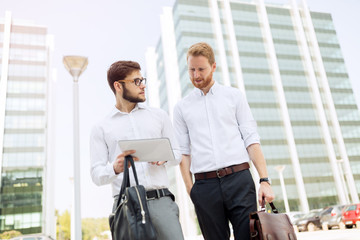 Wall Mural - Business colleagues in shirt walking outdoors