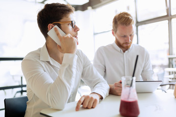 Sticker - Confident busy businessman working on tablet