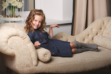 Little Funny Girl Posing On Sofa