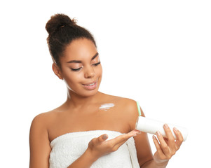 Poster - Beautiful young African American woman applying cream onto skin on white background