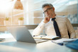 © goodluz - Businessman working on laptop in office, being concerned
