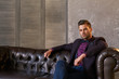 © Andrey Krupenko - Man model in dark jacket, purple shirt and blue trousers