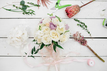 Gorgeous Wedding Bouquet Of Roses And Other Flowers Stands On The Florist's Working Table