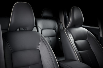 luxury car inside. interior of prestige modern car. comfortable leather seats. black perforarated le
