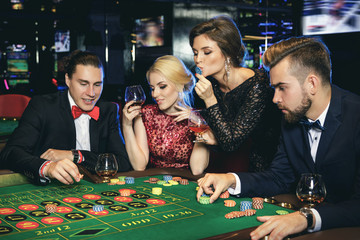 Young and rich people playing roulette in the casino