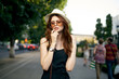 Beautiful woman with glasses and hat walking around the city