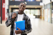 © Monkey Business - Portrait Of Male Student Standing In College Building