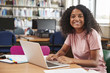 © Monkey Business - Portrait Of Female Student Working At Laptop In College Library